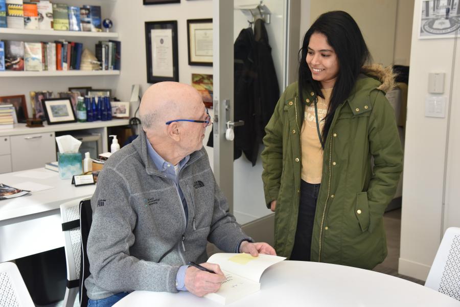 Yossi and student in his office - book signing